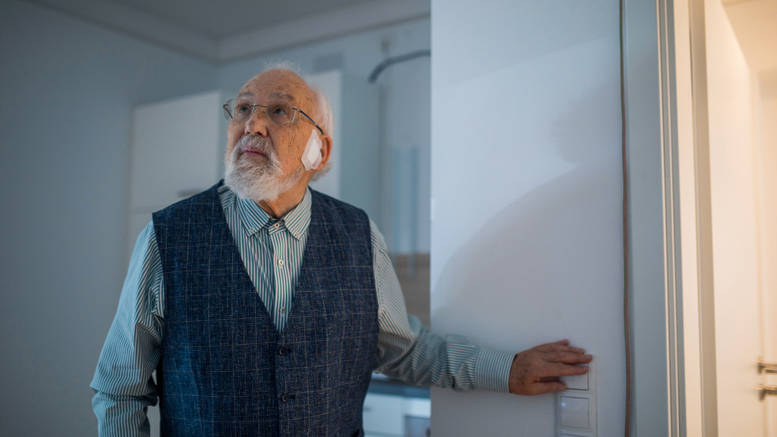 Ein Mann betätigt einen Lichtschalter im Bamberger Living Lab Demenz.