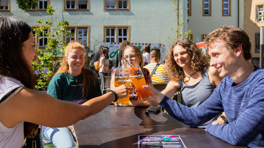 Eine Gruppe Studierende sitzt an einem Biertisch.